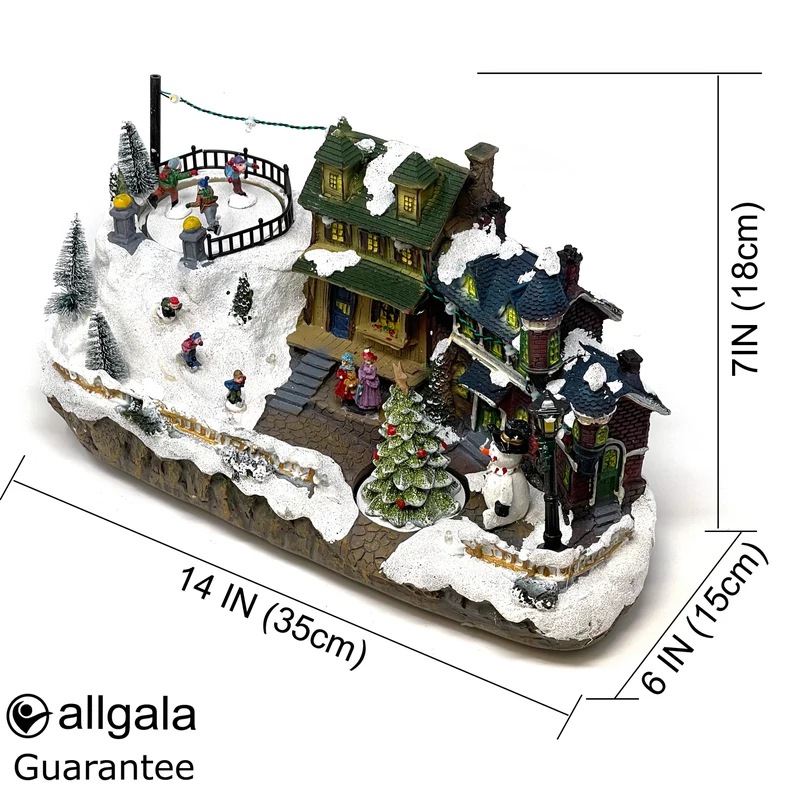 Villa navideña iluminada con nieve, figuras y casitas